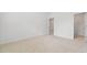Spacious bedroom painted a light neutral color featuring carpet and doors to access other rooms at 151 Rolling Hills Pl, Canton, GA 30114