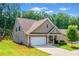 Side view of a craftsman-style home with a well-maintained lawn and a two-car garage at 151 Rolling Hills Pl, Canton, GA 30114