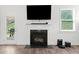 Living room fireplace with flatscreen TV and hardwood floors at 151 Rolling Hills Pl, Canton, GA 30114