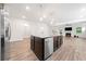 A kitchen island with stainless steel appliances and an open concept living area at 151 Rolling Hills Pl, Canton, GA 30114