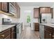 Kitchen featuring granite countertops, stainless appliances, and hardwood floors at 151 Rolling Hills Pl, Canton, GA 30114