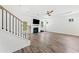 Bright living room features hardwood floors, a modern fireplace, and staircase access at 151 Rolling Hills Pl, Canton, GA 30114