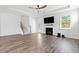 Spacious living room boasts wood floors, a fireplace, and ample natural light at 151 Rolling Hills Pl, Canton, GA 30114