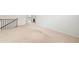 Large loft area with neutral carpeting and a staircase at 151 Rolling Hills Pl, Canton, GA 30114