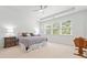 Bright main bedroom with carpet, ceiling fan, and three large windows at 151 Rolling Hills Pl, Canton, GA 30114