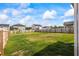 Large, fenced backyard with green grass and blue skies at 2296 Waycross Ln, Dacula, GA 30019