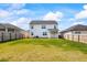 Spacious backyard with lush green grass, a wooden fence, and the home's rear exterior at 2296 Waycross Ln, Dacula, GA 30019