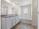 Bathroom featuring a double sink vanity and a tub with tile surround at 2296 Waycross Ln, Dacula, GA 30019