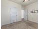 Carpeted bedroom features ceiling fan, mount for TV, and two doors at 2296 Waycross Ln, Dacula, GA 30019