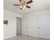 Bedroom featuring a ceiling fan, neutral carpet, and two doors at 2296 Waycross Ln, Dacula, GA 30019