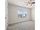 This bedroom features neutral carpet, a ceiling fan, and a window allowing natural light at 2296 Waycross Ln, Dacula, GA 30019