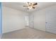 Carpeted bedroom featuring a ceiling fan and two doors at 2296 Waycross Ln, Dacula, GA 30019