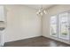 Bright dining area with chandelier and access to the backyard through glass doors at 2296 Waycross Ln, Dacula, GA 30019