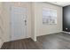 Bright entryway featuring wood-look floors, a modern white door, and natural light at 2296 Waycross Ln, Dacula, GA 30019