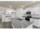 Well-equipped kitchen island with stainless steel sink, granite countertops, and ample lighting at 2296 Waycross Ln, Dacula, GA 30019