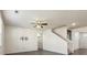 Open concept living room with ceiling fan, pre-wired for TV, and stairs to upper level at 2296 Waycross Ln, Dacula, GA 30019