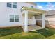 Covered patio area with white columns, concrete flooring, and a view of the backyard at 2296 Waycross Ln, Dacula, GA 30019