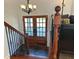 Inviting home entry featuring a wooden staircase, iron railings, and double doors with glass panes at 3962 Chicamauga Ne Dr, Kennesaw, GA 30144