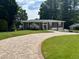 Charming brick home featuring a two-car garage, a spacious lawn, and a patterned brick driveway at 3962 Chicamauga Ne Dr, Kennesaw, GA 30144