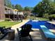 Outdoor pool area with a diving board, deck, and a covered patio with outdoor seating at 3962 Chicamauga Ne Dr, Kennesaw, GA 30144