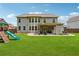 Expansive backyard features a covered patio, play area, and lush green lawn at 422 Silver Brook Dr, Woodstock, GA 30188