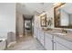 Bright bathroom with double vanity, granite counters and an open view to the main bedroom at 422 Silver Brook Dr, Woodstock, GA 30188