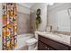 Cozy bathroom featuring granite countertop, a bathtub and shower combo, and decorative wall planters at 422 Silver Brook Dr, Woodstock, GA 30188
