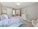 Bright bedroom with white dresser, unique comforter and plush carpeting at 422 Silver Brook Dr, Woodstock, GA 30188