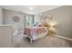 Charming bedroom with decorative wall art, a bed with a metal frame, and neutral colors at 422 Silver Brook Dr, Woodstock, GA 30188
