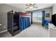 This room has a wooden bunk bed, ceiling fan, plush blue chair, and an exterior view at 422 Silver Brook Dr, Woodstock, GA 30188