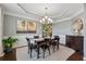Elegant dining room featuring a tray ceiling, chandelier, and stylish decor at 422 Silver Brook Dr, Woodstock, GA 30188