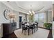 Elegant dining room featuring a tray ceiling, chandelier, and stylish decor at 422 Silver Brook Dr, Woodstock, GA 30188