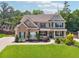 Inviting two-story brick home with a manicured lawn, black shutters, and charming front porch at 422 Silver Brook Dr, Woodstock, GA 30188
