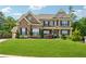 Inviting two-story brick home with a manicured lawn, black shutters, and charming front porch at 422 Silver Brook Dr, Woodstock, GA 30188