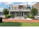 Charming two-story commercial building with awnings, large windows, and a rooftop patio at 422 Silver Brook Dr, Woodstock, GA 30188