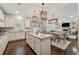 Open kitchen and dining area with granite countertops, stainless appliances, and a seamless transition to the living space at 422 Silver Brook Dr, Woodstock, GA 30188