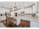 Modern kitchen with stainless steel appliances, granite countertops, island seating and beautiful pendant lighting fixtures at 422 Silver Brook Dr, Woodstock, GA 30188