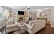 Inviting living room with a stone fireplace, built-in bookshelves, and comfortable seating, perfect for relaxation at 422 Silver Brook Dr, Woodstock, GA 30188