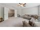 Large living room with neutral carpeting, ceiling fan and view to the landing at 422 Silver Brook Dr, Woodstock, GA 30188