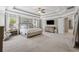 A bright main bedroom featuring neutral colors, TV, and carpeted floors at 422 Silver Brook Dr, Woodstock, GA 30188