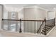 Upstairs landing with decorative metal railing overlooking foyer below at 422 Silver Brook Dr, Woodstock, GA 30188