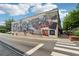 Street view of a building featuring a large mural, sidewalk, trees, and crosswalk in the Woodstock area at 422 Silver Brook Dr, Woodstock, GA 30188