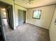 Bedroom showcasing carpet flooring, neutral walls, and an open closet at 50 Evelyn Rd, Covington, GA 30016
