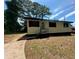 Charming single-story home featuring a minimalist design and a well-kept lawn in a suburban neighborhood at 50 Evelyn Rd, Covington, GA 30016