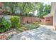Backyard with a mini-golf setup, beautiful plants, stone wall, and privacy at 10280 Medridge Cir, Johns Creek, GA 30022