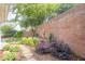 Beautifully landscaped backyard with brick retaining wall and stone pathway at 10280 Medridge Cir, Johns Creek, GA 30022