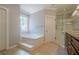 Bathroom with corner tub and glass enclosed shower at 10280 Medridge Cir, Johns Creek, GA 30022
