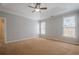 Bedroom with tray ceiling, carpet and ample natural light at 10280 Medridge Cir, Johns Creek, GA 30022