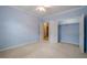 This bedroom offers neutral carpet, blue walls, a ceiling fan and a closet for plenty of storage space at 10280 Medridge Cir, Johns Creek, GA 30022