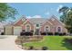 Beautiful brick home with a well-manicured lawn and a two-car garage at 10280 Medridge Cir, Johns Creek, GA 30022